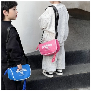 Close-up of blue and pink canvas kids crossbody bags with adjustable buckle straps