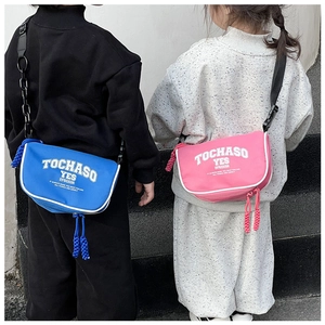 Close-up of blue and pink canvas crossbody bags for kids with adjustable black straps
