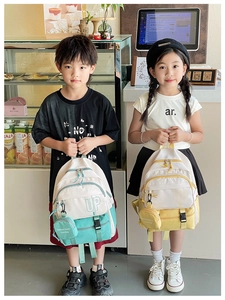Detail of color-block kids backpack with UP logo and matching small hanging pouch