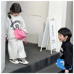 Close-up of children wearing casual sporty sweatshirts with colorful crossbody bags
