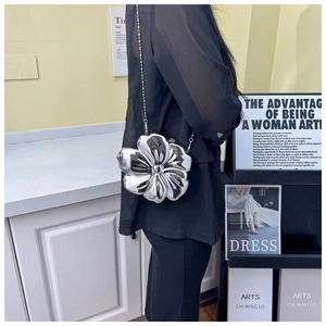 Silver metallic flower-shaped shoulder bag with mirror finish and slim metal chain