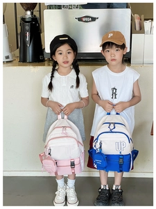 Detail of pink and blue kids backpacks with UP print and detachable coin purses