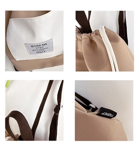Detail of canvas backpack featuring drawstring closure and stylish contrast stitching