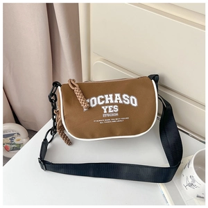 Detail of vintage canvas kids crossbody bag in brown with white trim and wide strap