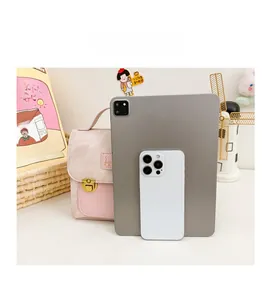 Pink mini crossbody bag size comparison with tablet and phone showing compact dimensions