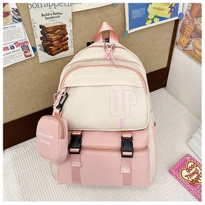 Close-up of pink and white kids backpack with front zipper pocket and side pouch
