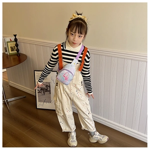 Close-up of cute purple canvas chest bag for kids with cartoon mermaid print details