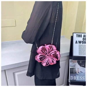 Close-up of metallic pink flower-shaped chain bag with reflective electroplated finish