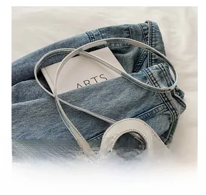 Détails du mini sac en cuir verni argenté avec poignée anneau et fine bandoulière réglable