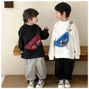 Kids trendy canvas chest bags in red-purple and blue shown with adjustable straps
