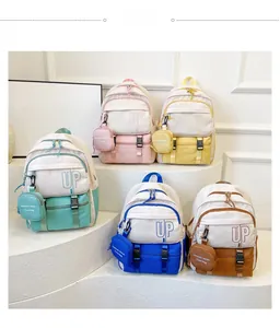 Detail showing five colorful canvas backpacks with UP lettering and round coin purses