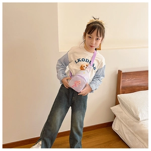 Close-up of kids purple canvas chest bag featuring cartoon mermaid design on young girl