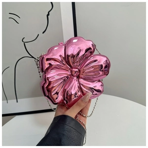 Close-up of pink metallic 3D flower clutch bag with silver bead chain and reflective finish