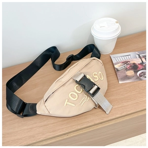 Detail of beige canvas kids waist bag with yellow TOCOSO embroidery and black strap