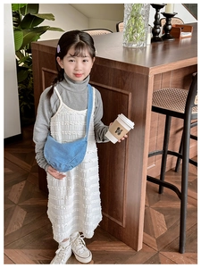 Girl wearing white strap dress with grey top and blue denim crescent crossbody bag
