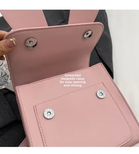 Detail view of pink leather bag featuring invisible magnetic buckles and internal closure