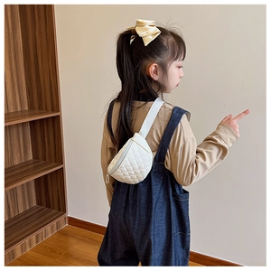 Close-up of white quilted chest bag for kids with adjustable strap and metal zipper