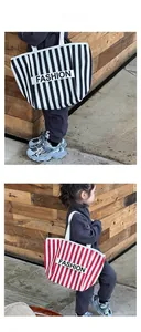 Detailed close-up of kids striped canvas tote bag with fashion letter patch and woven handles