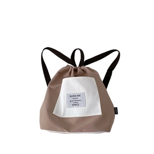 Fashionable beige drawstring backpack for kids with a large capacity and contrast design