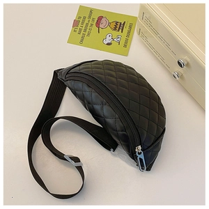 Detail of black quilted leather fanny pack for kids with silver zipper and buckle