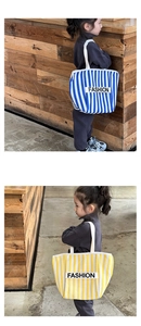 Detail of striped canvas tote bags for kids with white webbing handles and fashion label