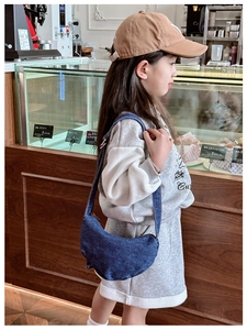 Detail of blue denim crescent crossbody bag for kids with adjustable strap and zipper