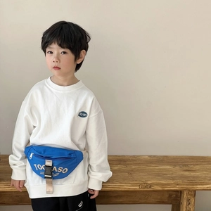 Stylish blue canvas fanny pack with TOCASO logo worn by a child with a white sweatshirt