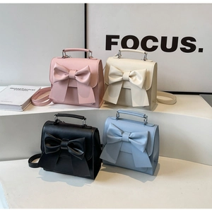 Detail of four colorful chic handbags featuring large bow accents and versatile straps