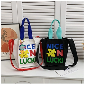 Gros plan d'un sac bandoulière enfant en toile avec motif smiley et texte coloré