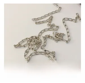 Close-up of polished silver metal chain strap with rectangular links for kid shoulder bag