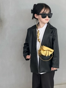Detail of a shiny metallic gold saddle bag for girls with high-quality mirror finish