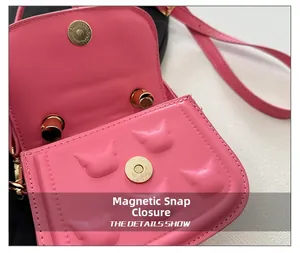 Detail of pink quilted crossbody bag for kids featuring a magnetic closure and cat embossing