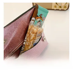 Detailed view of the pink glitter crossbody bag showing its interior storage capacity