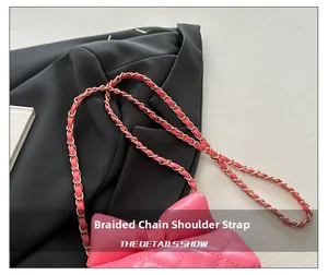Close-up of pink quilted bag featuring a decorative bow and woven metal chain strap