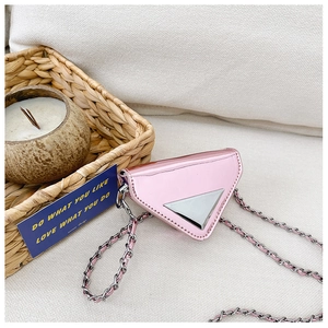 Detail of pink metallic triangle mini bag with silver chain and glossy finish