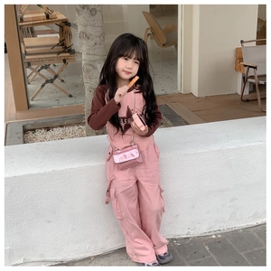 Detail of pink cargo pants with side pockets and star pattern top for young girls