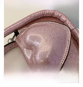 Detail shot of shimmering pink sequin fabric with high-quality stitching on children bag
