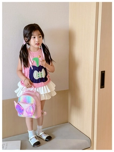Close-up of pink sequin backpack with rainbow gradient wings and pearl handle for girls