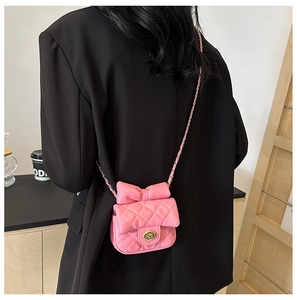 Pink quilted crossbody bag for girls with a stylish bow decoration and chain strap