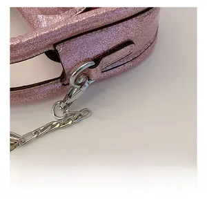 Detail of silver metal hook and chain on pink sequin shoulder bag for kids