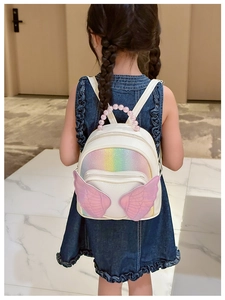 Close-up of pink beaded handle and glitter wings on a white cartoon toddler backpack