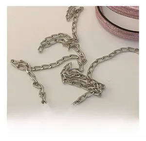 Detail of silver metallic chain strap for kids heart bag showing polished rectangular links