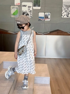 Chic silver saddle bag paired with a gray sleeveless top and printed dress for girls