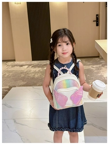 Close-up of kids backpack featuring rainbow sequins and a pink pearl top handle strap