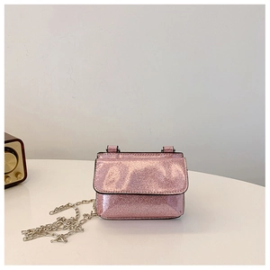 Detail of glittery pink mini crossbody bag with silver chain strap and sequin texture