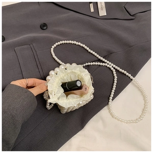 Detail showing the inner drawstring lining and capacity of the mini pearl beaded bag