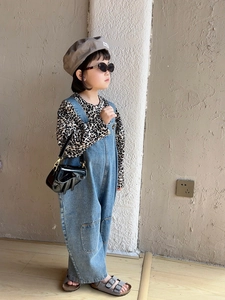 Fashionable black laser finish saddle bag shown with child model stylish outfit