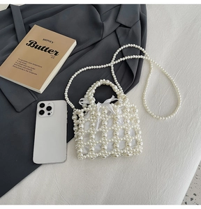 Close-up of white pearl woven handbag with hollow mesh and satin drawstring lining