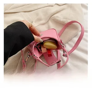 Capacité interne du mini sac à bandoulière rose contenant du maquillage
