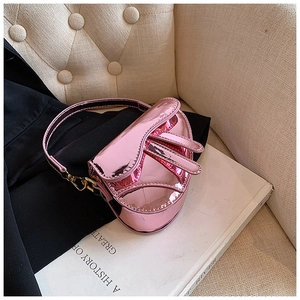Macro shot of metallic pink saddle bag showing high-gloss mirror PU leather finish
